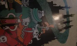Kolorowy komiks z postaciami w stylu fantasy, przypominającymi bohaterów gry o nazwie "dożon". W tle widać zarys zamku.