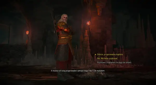 Geralt w zbroi stoi w jaskini, w cieniu wiecznego ognia. W tle widać pochodnie i stalaktyty.