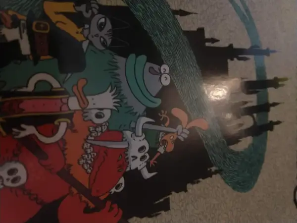Kolorowy komiks z postaciami w stylu fantasy, przypominającymi bohaterów gry o nazwie "dożon". W tle widać zarys zamku.