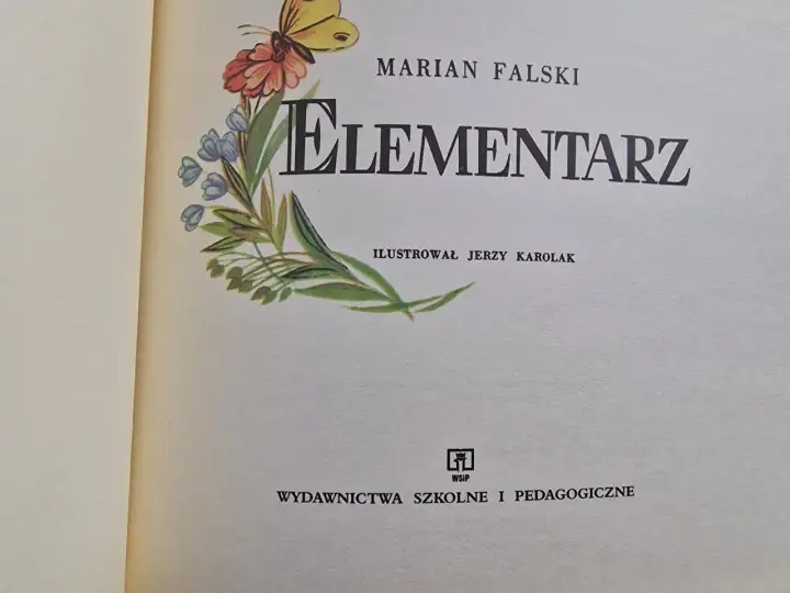 Ilustrowany elementarz z lat 60. Mariana Falskiego, z motywem motyla i kwiatów.